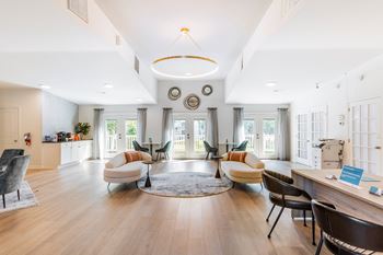 a living room with couches and chairs and a round rug